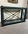 Striking vintage Neoclassical console table featuring a substantial wood frame finished in a richly mottled faux-verdigris...