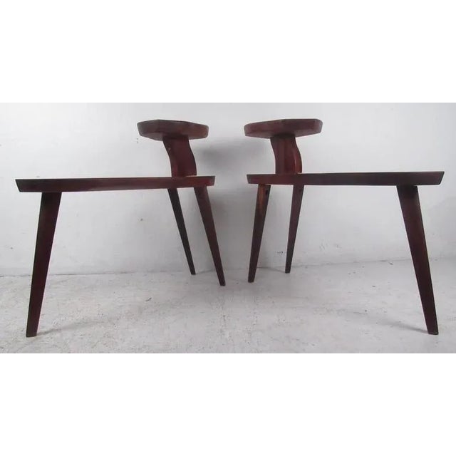 Pair of studio-made two-tier walnut end tables with tapered legs. with dealer. Dimensions: 14.25w 32.25d 30.25h Condition:...