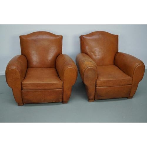 These club chairs were designed and produced in France during the 1940s. The chairs are made from cognac leather held...