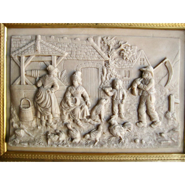 This lovely frame from the 18 hundreds is a limestone Bas relief representing a village scene , this is also called...