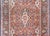 A playful early 20th century Persian Kashan rug with a wonderful central floral medallion woven in crimson, indigo, coral,...