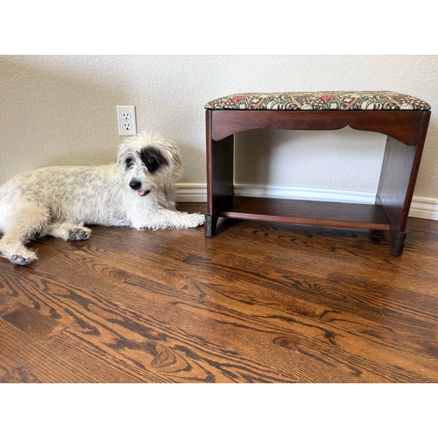 A charming Art Deco vanity bench featuring a warm brown wood finish, gracefully shaped apron, and newly upholstered seat...