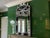 A tall French Venetian-style wall mirror with a rectangular central plate framed by bluish-black glass panels overlaid...