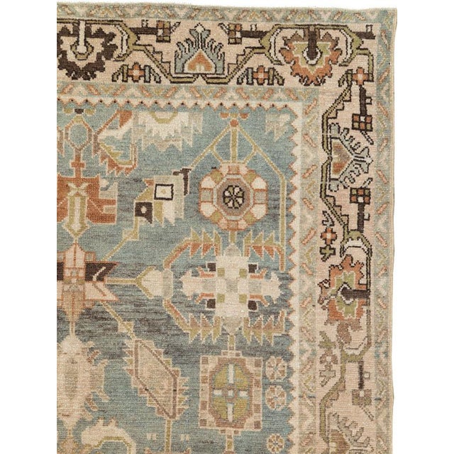 This mid-20th-century Persian Malayer accent rug presents a balanced floral and geometric composition across a muted blue-...