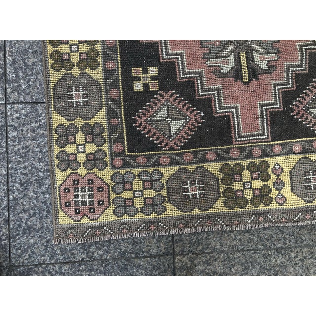 This is a vintage Turkish Oushak rug from the 1960s. The piece was hand-knotted.