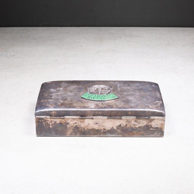 ABOUT A mid-century silver plated commemorative presentation box lined with sandlewood. The lid features a detailed emblem...