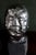 A set of 3 sculptural heads in a Brutalist or simplified style. Pottery with a shiny silver and matte black glaze. Very...