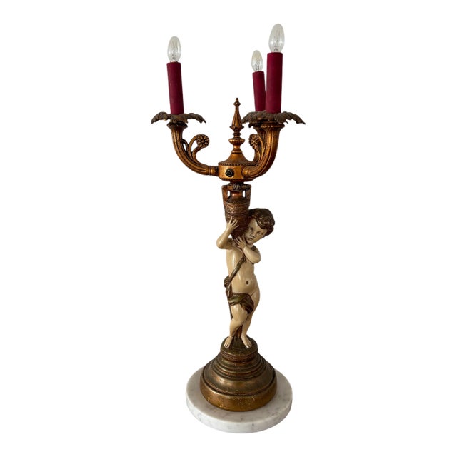 Antique Neoclassical Figural Candelabra Table Lamp, Featuring a Cherub or Putti Figurine Holding a Candelabra, on a Marble Base For Sale