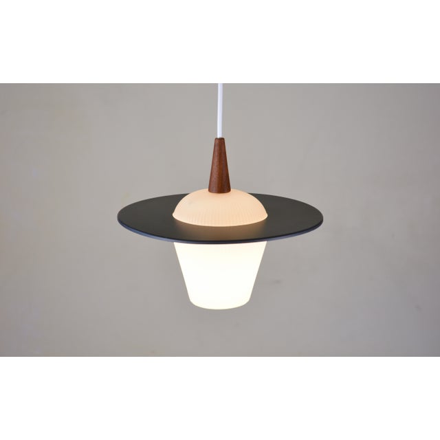 A distinctive lyfa pendant lamp from denmark, dating from the 1950s, with an unusual sculptural combination of moulded...