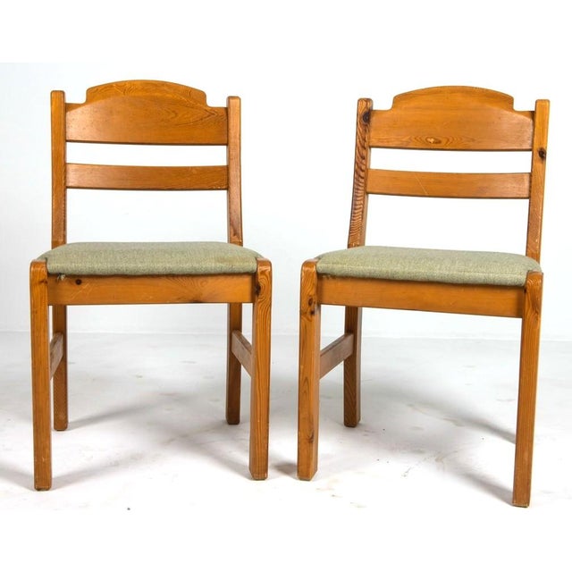A set of 6 1970's Scandinavian modern (Sweden) dining chairs. Chairs are pine and are upholstered in a simply light gray...