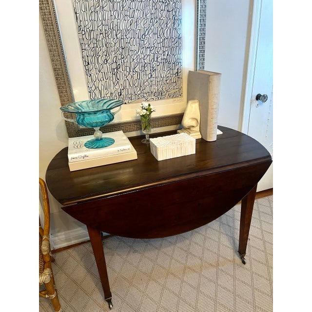 A beautifully hand crafted Directoire Drop leaf table with Brass Sabot's / wheels. Easily moved from one room to another....