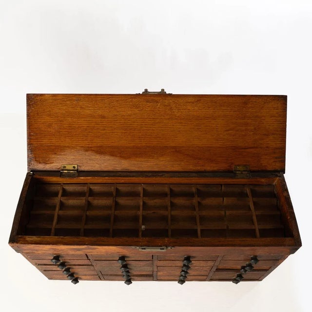 This antique oak table top 20 drawer watchmaker's chest originally held watch springs and other parts.