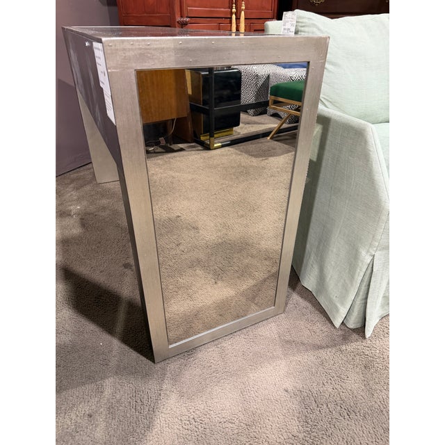 Add a touch of glamour and modern sophistication to your space with this striking mirrored entry table. Designed to...