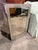 Add a touch of glamour and modern sophistication to your space with this striking mirrored entry table. Designed to...