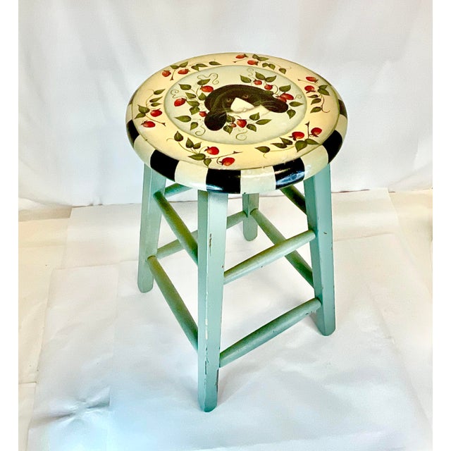This is a delightful painted vintage counter stool. It features a black bunny on the seat with strawberries and black and...