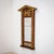 Wall mirror with a mahogany-veneered frame and giltwood elements, featuring a pediment top and flanking half-columns with...