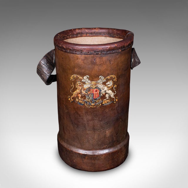 This is a vintage decorative stick stand. An English, leather basket or storage bin, dating to the early 20th century,...