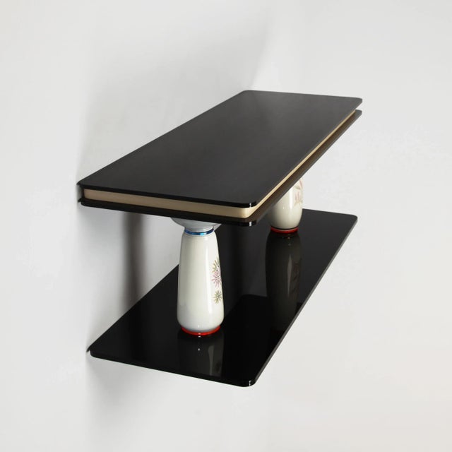 Timeless small sculptural wall shelf composed of vintage vases combined with high-end Acrylic glass components. The wall...