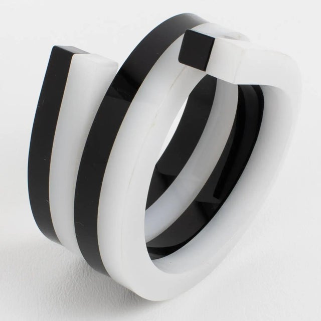 This stunning, important Space Age sculptural Lucite bracelet bangle features a chunky coiled-wrapped shape with squared...