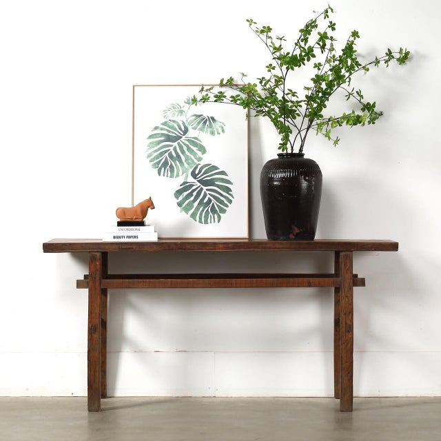 This vintage console table is handcrafted from solid pear wood and finished in a beautifully weathered natural tone. Its...