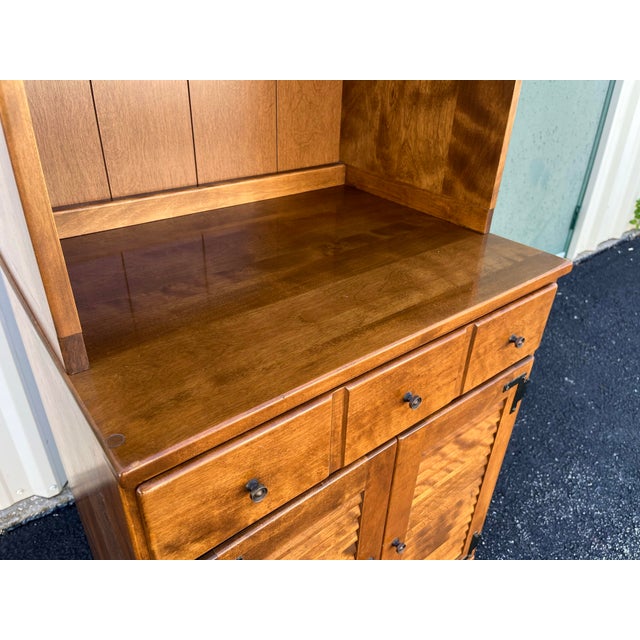A two-piece hutch cabinet made by Ethan Allen in the late 20th century. Constructed with maple and birch hardwoods, this...