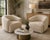 A sophisticated pair of contemporary swivel lounge chairs purchased from Arhaus, featuring sculptural curved silhouettes...