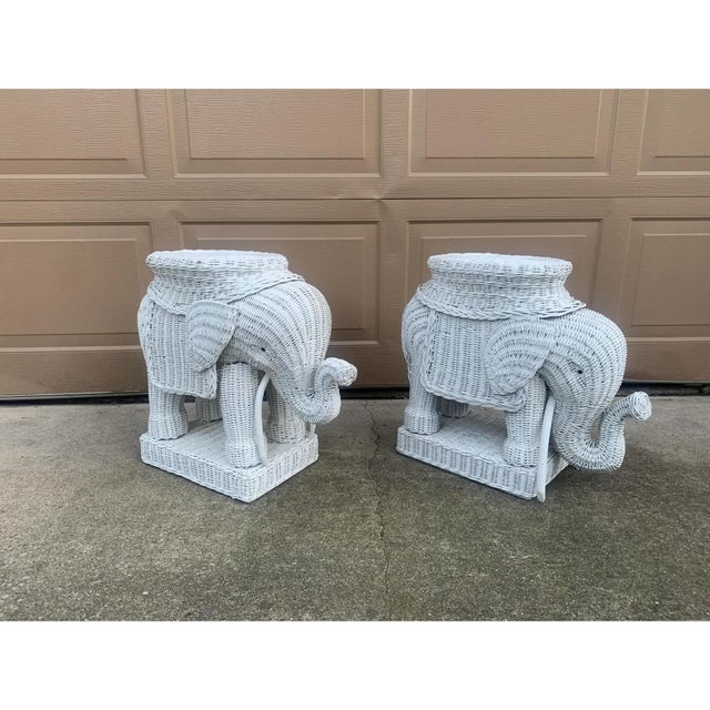 A charming pair of Mid-Century wicker rattan white elephant garden stools or side tables. This whimsical pair would be...