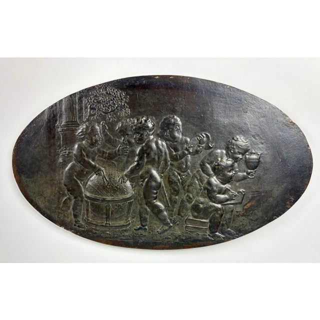 A large late 17th Century Franco-Flemish bronze plaquette of naked putti around a globe in a classical setting, unsigned....
