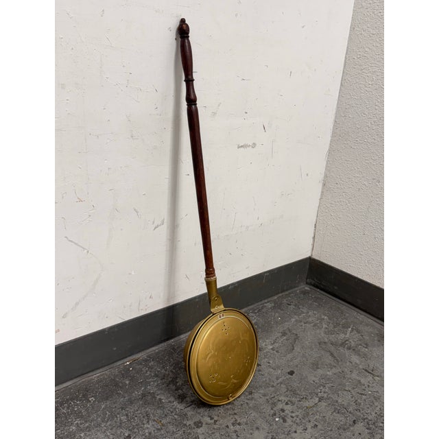 Design Plus Gallery presents an Antique Brass Bed Warmer with Turned Wood Handle. This brass warming pan has a round...