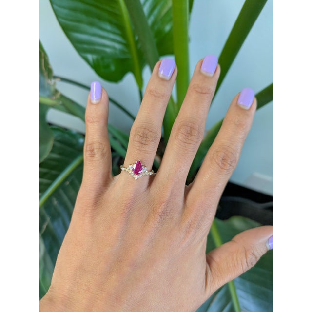 A 1.1-carat pink sapphire glows in a soft, romantic pink at the center of this solid 14K yellow gold ring, cut as an...