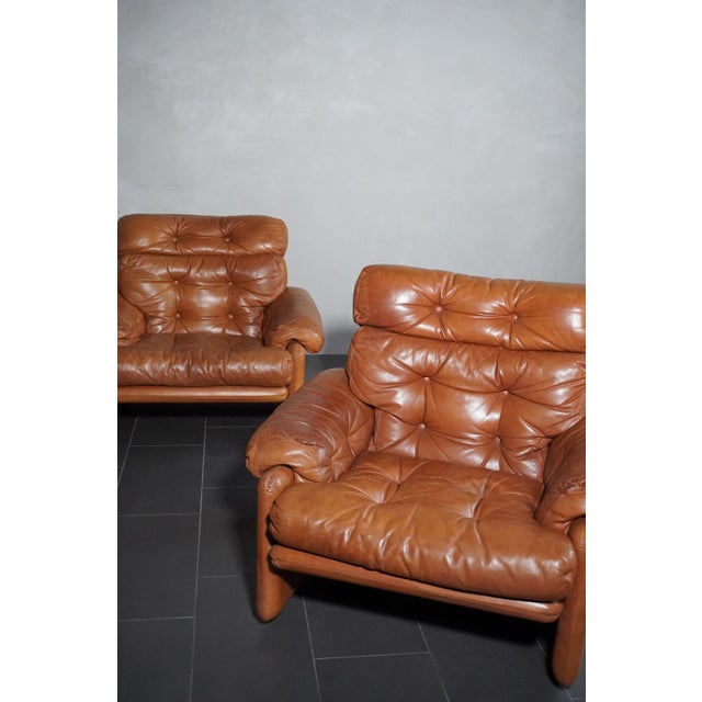 A pair of Coronado armchairs by Afra and Tobia Scarpa for C&B, a one-off, in cognac-colored leather. They are in excellent...