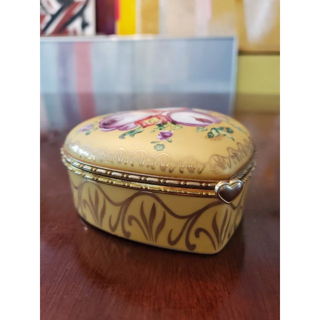 A very unusual vintage mid century Era heart shaped jewelry box. In the style of sevres in rich yellow porcelain with hand...