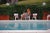 Lounging In Bermuda 1969 by Slim Aarons Slim Aarons Limited Estate Edition A woman relaxes with a drink by a swimming pool...