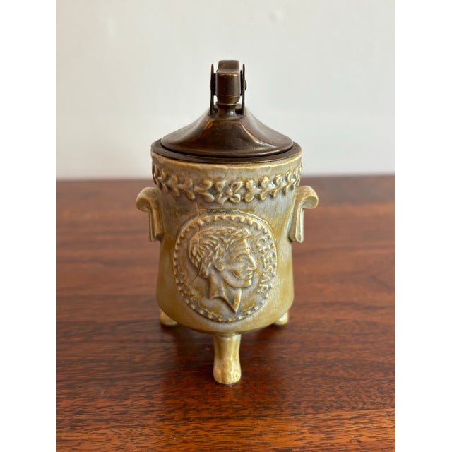 Rare midcentury neoclassical embossed Caesar tabletop lighter. Please see condition details noted. Most items found at Pub...