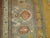 An early 20th century Turkish Ghiordes carpet with an all-over sunny yellow motif and green border. Measures: 12'6" x...
