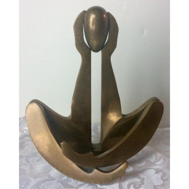 An abstract bronze sculpture by Arleen Eichengreen and Nancy Gensburg. The formed bronxe suggests a seated figure with...