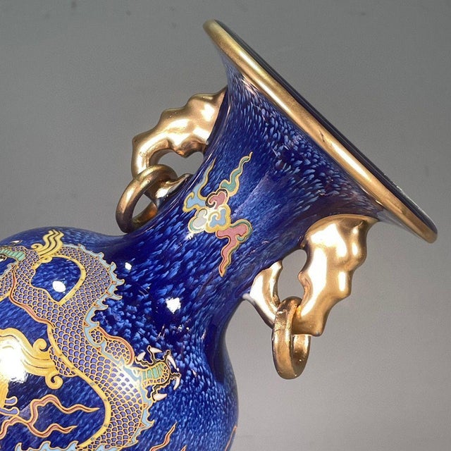 Make a bold statement with this striking cobalt blue ceramic vase, featuring a magnificent, detailed dragon motif. The...