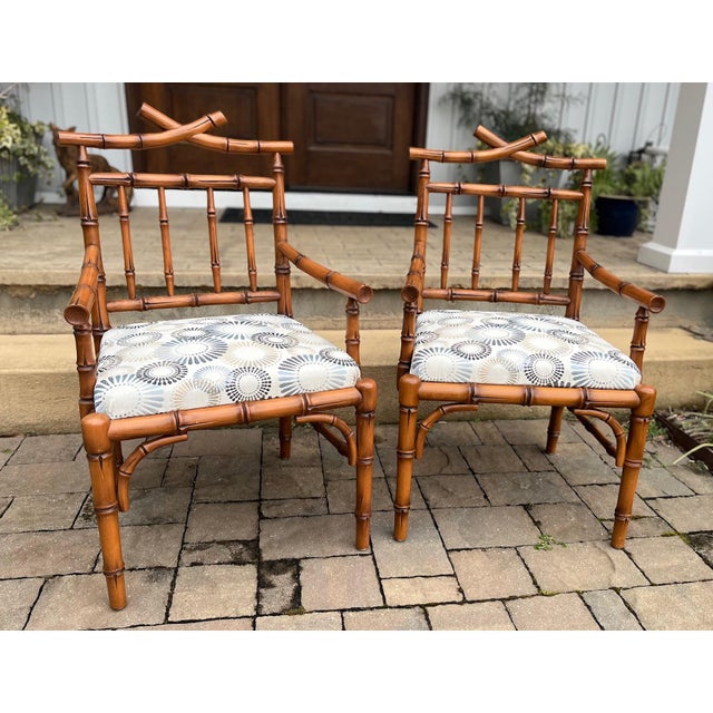 Beautiful pair of Chinoiserie influenced faux bamboo chairs by Mark David. Unique design invokes a pagoda inspired...
