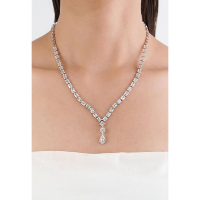 This elegant Drop Necklace showcases 6.24 carats of natural diamonds, set in a 14k white gold. Mix of baguette and pear...