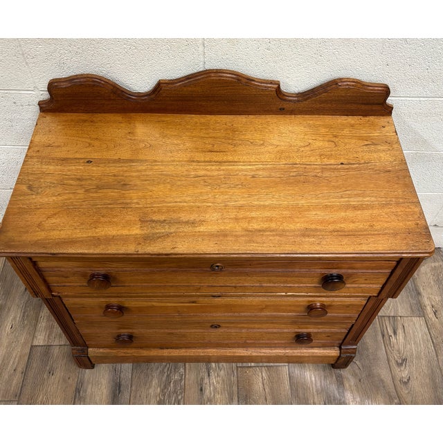 This is a beautiful antique Victorian dresser or chest with three large dovetailed drawers, round wooden pulls, and a...