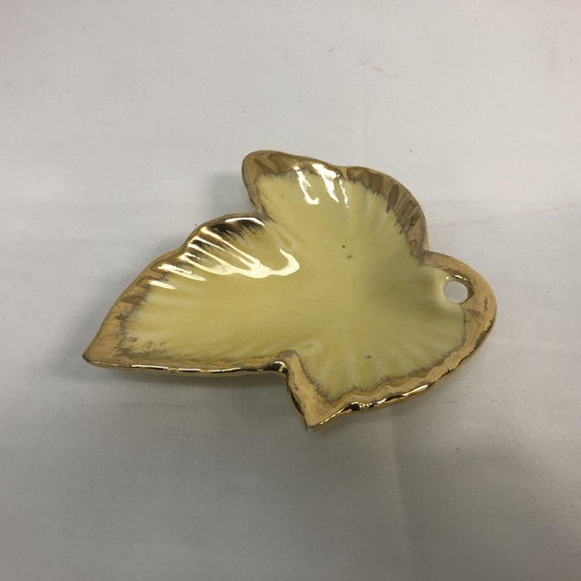Beautiful vintage yellow ceramic dish with gold leaf edging. Perfect for collectors, as a jewelry dish, or anything...
