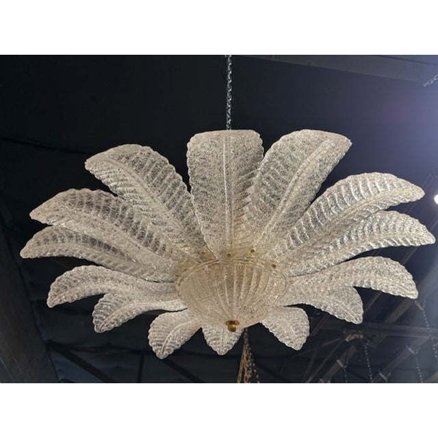 This modern clear "granola" Murano glass flush mount leaf form chandelier exudes a sleek and stylish design perfect for...