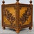 A richly carved 19th-century French jardinière featuring caned panels, classical torches, abundant foliage, and four...