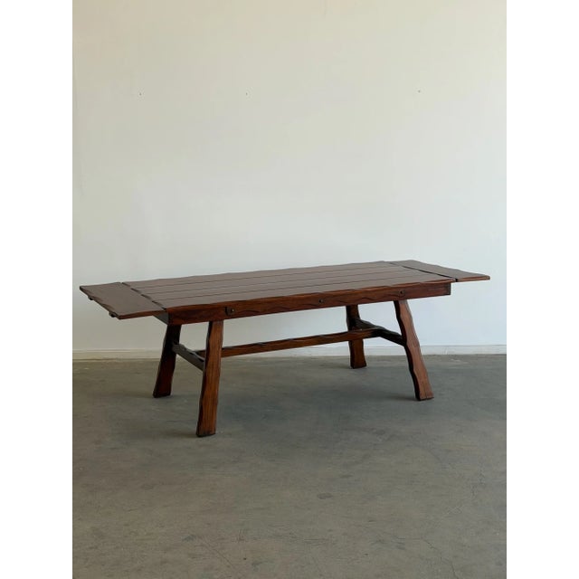 W75 - W95 D35 H30.5 KC25.75 The “1940’s Trestle Dining Table with Leaf Extensions” is a vintage dining table with distinct...