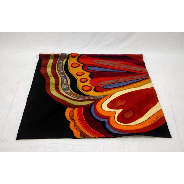 This multi-color wall hanging depicts half of a large butterfly wing. It is signed on the front by Helen Webber and has an...