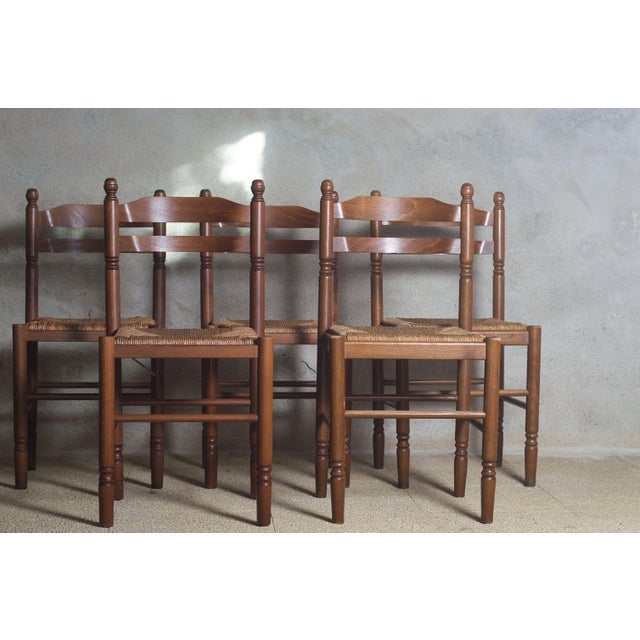 A charming set of five antique wooden chairs, exuding warmth and authenticity. The backrests are composed of gently...