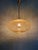 Large vintage pendant light in clear glass inlaid with gold glitter and a brass frame. Origin: Germany, 1970s. The pendant...