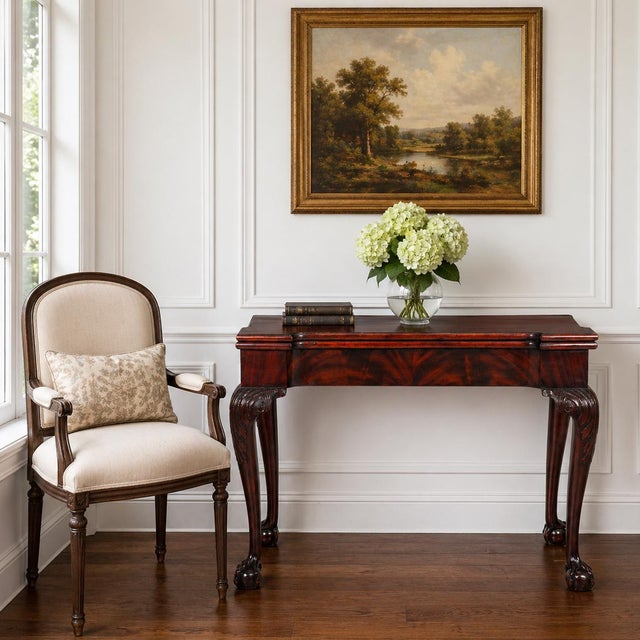 GEORGE III FLAMED MAHOGANY DOUBLE GATE-LEG CARD TABLE England, circa 1770 Raised on ball-and-claw feet 28 3/4" H x 17" D x...