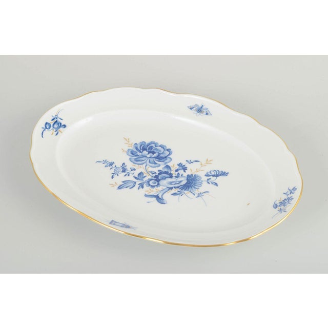 Meissen Oval dish, early 20th century. Hand-decorated porcelain with hand-painted blue floral motifs and gilt accents...