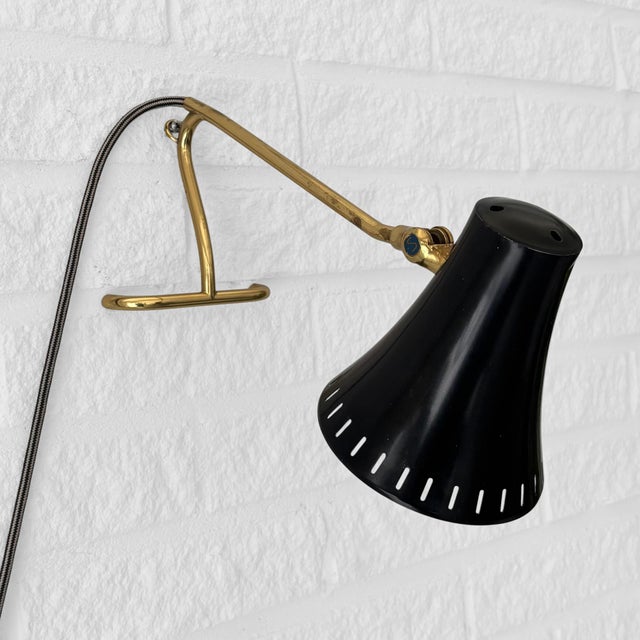 A sculptural table or wall lamp, model 8256, produced by the Swedish manufacturer Boréns in the 1950s. Crafted with a...